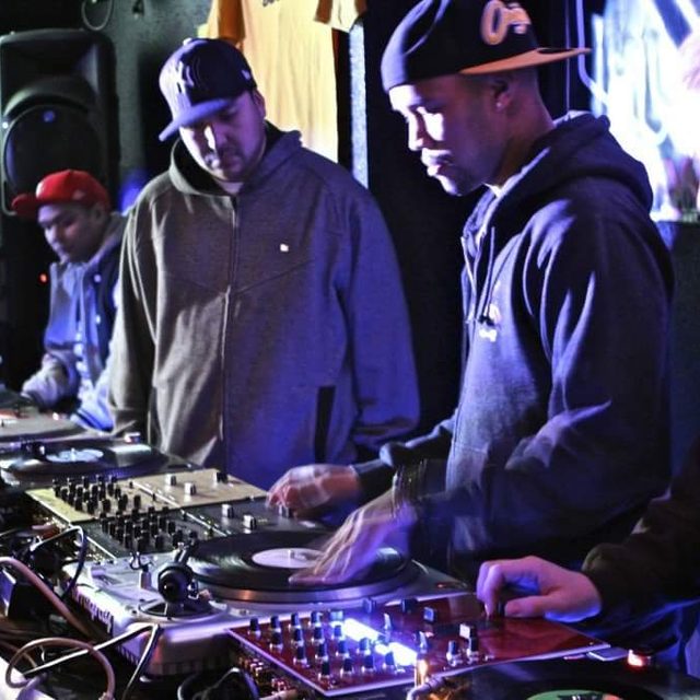 deejaypryme performing alongside other DJs at a turntable showcase