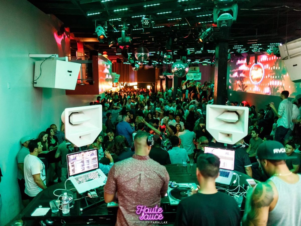 Full club floor dancing under stage lighting during a deejaypryme set