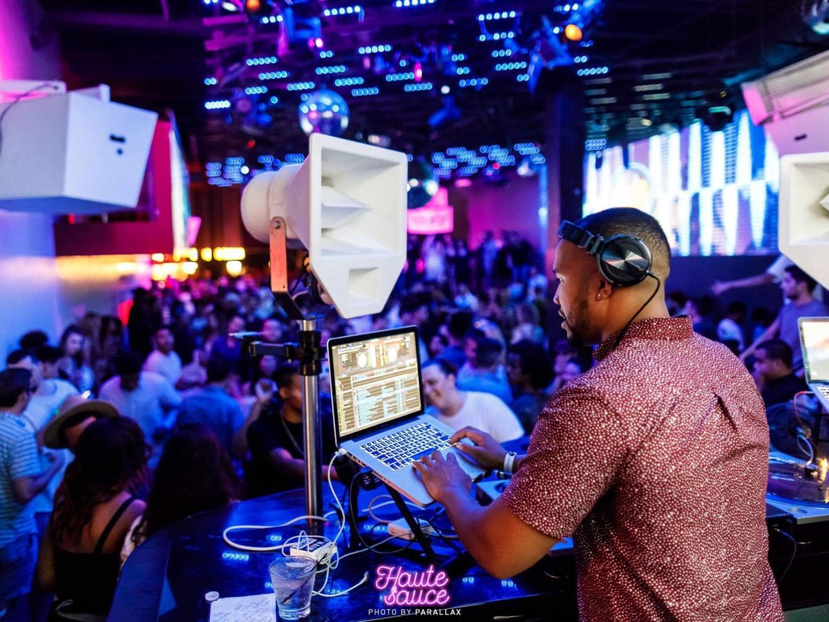 deejaypryme working the booth mid-set with the dance floor behind him